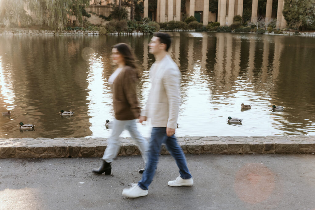 couple walking by lake at palace of fine arts in san francisco
