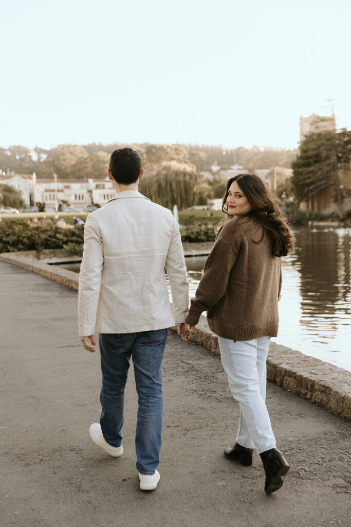 couple walking by lake at palace of fine arts in san francisco