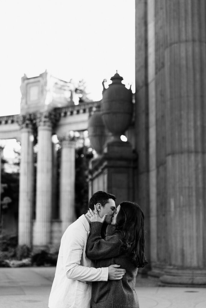 black and white photo of couple kissing at palace of fine arts san francisco